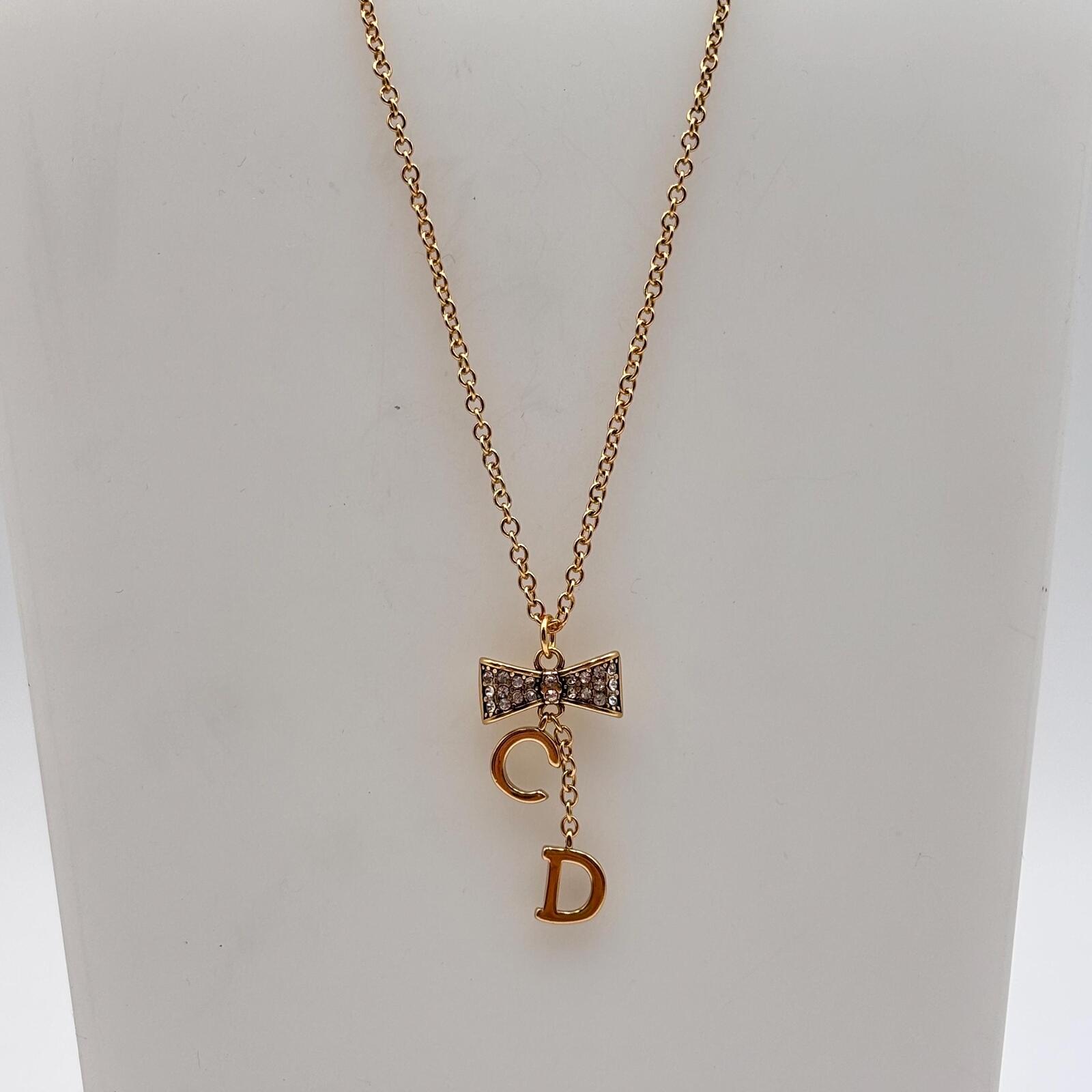Christian Dior Gold Tone CD Bow Pendant Necklace