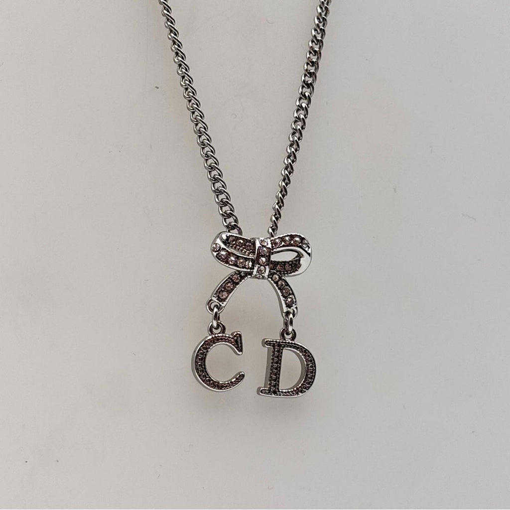 Christian Dior CD Bow Pendant Necklace Silver Tone Crystal Logo