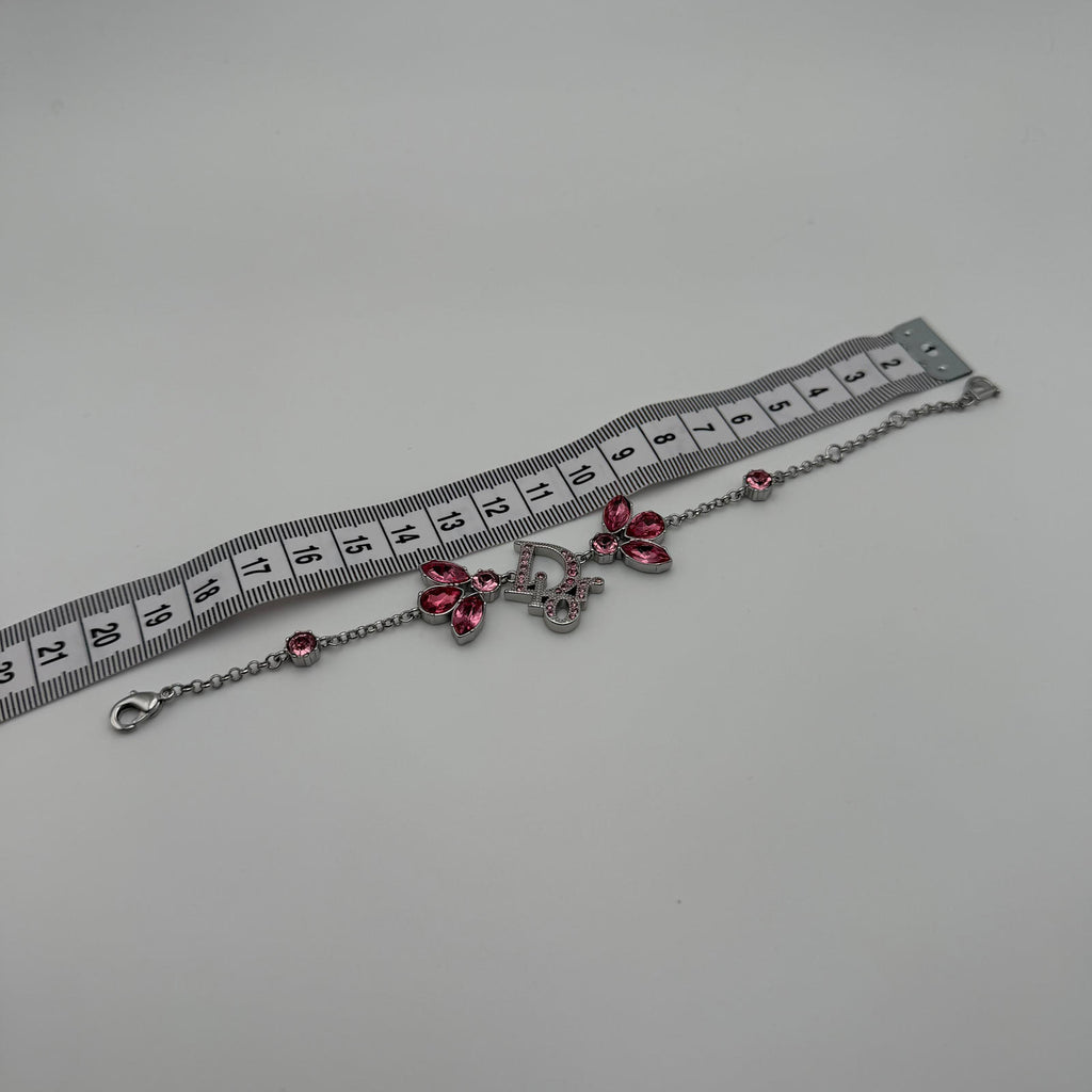 CHRISTIAN DIOR PINK CRYSTAL LOGO BUTTERFLY BRACELET
