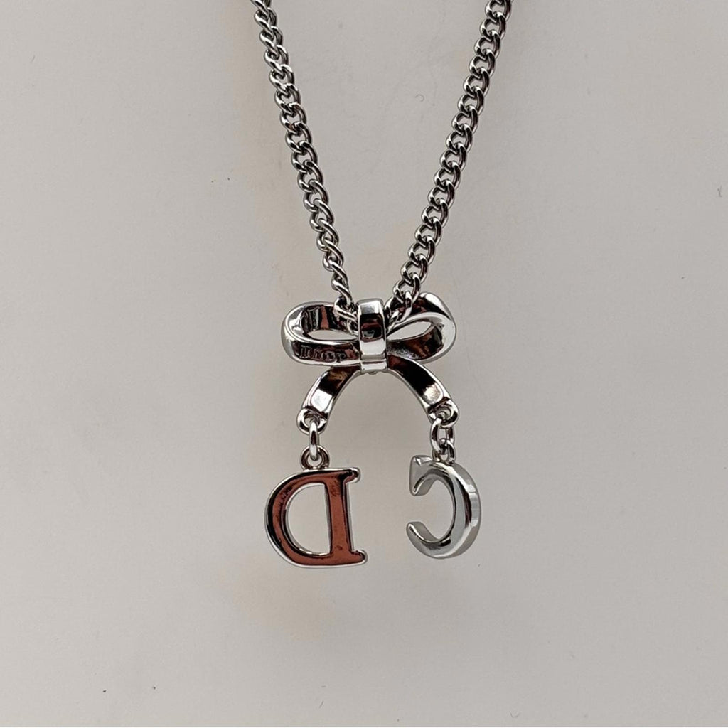 Christian Dior CD Bow Pendant Necklace Silver Tone Crystal Logo