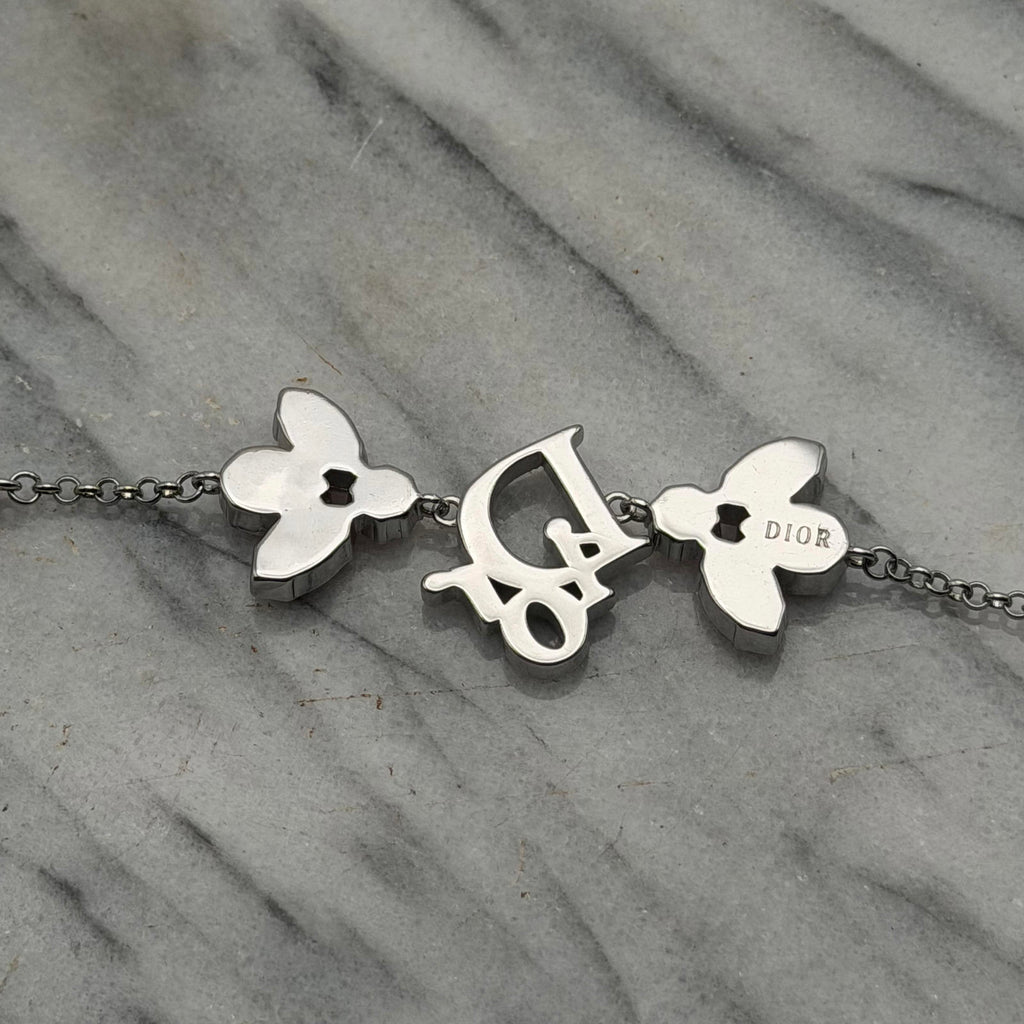 CHRISTIAN DIOR PINK CRYSTAL LOGO BUTTERFLY BRACELET
