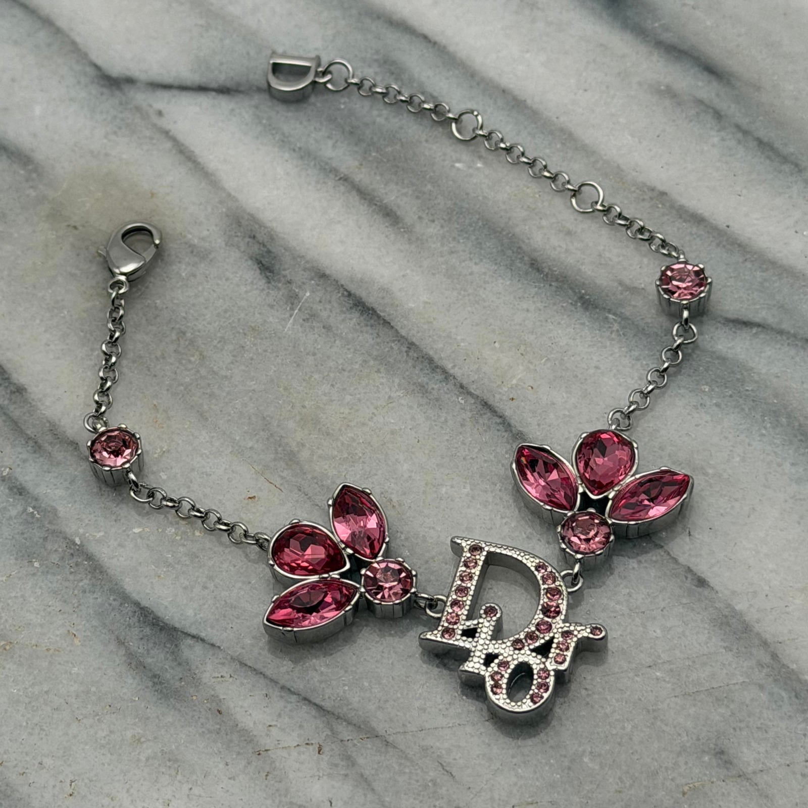 CHRISTIAN DIOR PINK CRYSTAL LOGO BUTTERFLY BRACELET